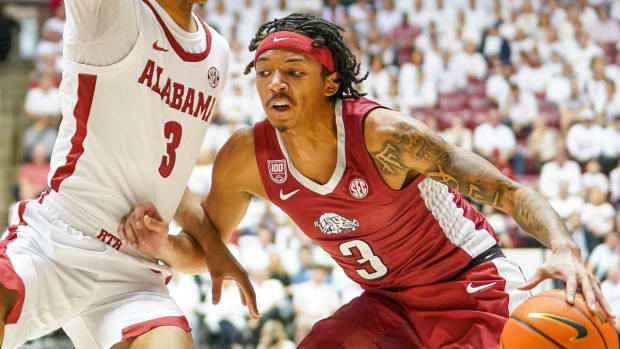 Arkansas Razorbacks guard Nick Smith Jr. against Alabama Crimson Tide guard Rylan Griffen.